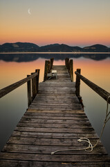 Fototapeta premium pier at sunset on a tuscany lake