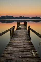 Fototapeta na wymiar pier at sunset on a tuscany lake