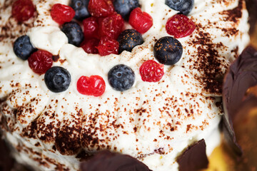 cream cake with chocolate and berries