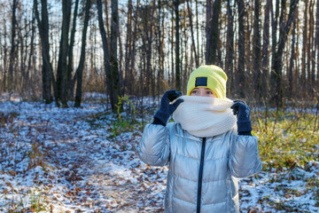 Young Girl Wearing Scarf instead of Protective Mask Walking in Winter Park