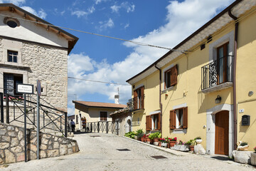 A narrow street among the old houses of Scontrone, a medieval village in the Abruzzo region, Italy.