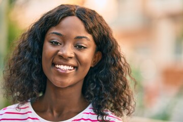 Young african american girl smiling happy standing at the city.