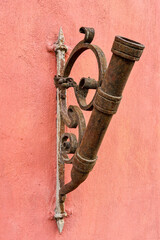 antique looking flagpole holder on the house wall