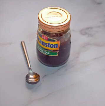 Norwich, Norfolk, UK &ndash; September 22 2020. An illustrative photo of a close up of a glass jar of Branston original pickle on a marled white worktop