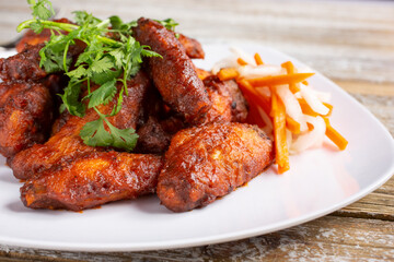 A view of a plate of spicy Thai chicken wings.