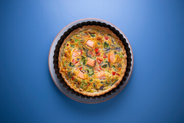 Traditional salmon quiche with broccoli and vegetables