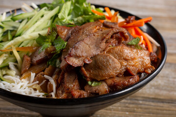 Fototapeta premium A view of a bowl of Vietnamese vermicelli noodles, also known as bún, featuring marinated beef.