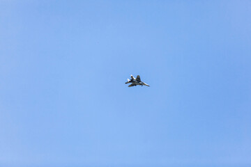 military white airplane flying in blue sky. selective focus.