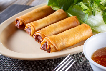 A view of a plate of egg rolls.