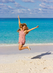 happy woman jumping on the beach