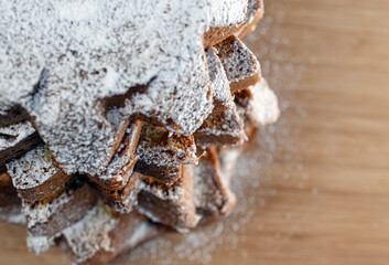 Powdered sugar sprinkled on a festive Chrismas Pandoro cake cut in star-shaped layers