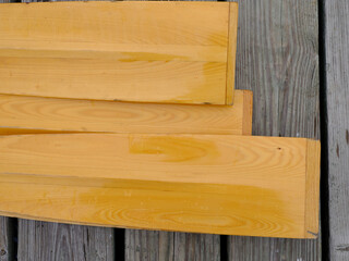 Classic wooden oars sit on a wooden dock on the Maine Coast