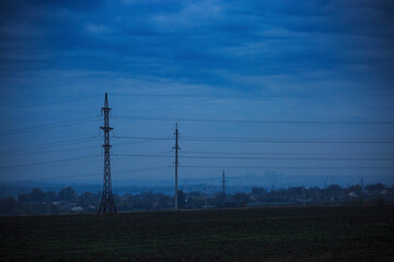 High voltage power line in cloudy twilight