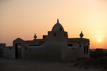 Historic mosque during sunset  in the mid of the remains of a ancient village at Hawar island, Bahrain