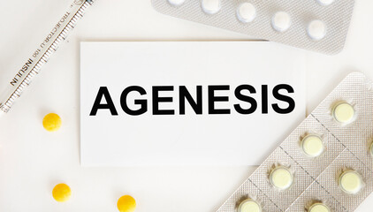 On the card text AGENESIS, next to blisters with tablets, syringe, yellow tablets.