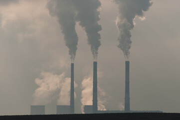 
smoke coming from cooling towers and production pipes.