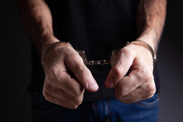 Fototapeta premium men handcuffed in criminal concept