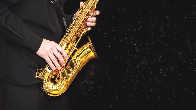 Loop video Saxophone with dust effec Player hands Saxophonist playing jazz music. Alto sax musical instrument closeup on black background