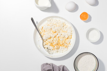 Step-by-step recipe - Cottage cheese, eggs, cream and yougurt on a white background - Flat lay