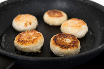 Step-by-step recipe - Curd pancakes are frying in a black pan