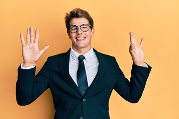 Handsome caucasian man wearing business suit and tie showing and pointing up with fingers number eight while smiling confident and happy.