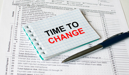 Fototapeta premium Notepad with text Time To Change lying on financial tables with a pen