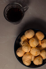 Brazilian snack callled cheese bread 'pao de queijo'  with cup of coffee, homemade cheese buns. typical snack from minas gerais, Brazil.