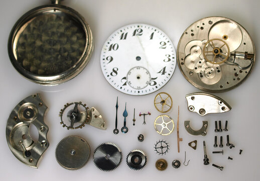 display of parts of vintage watch mechanism: dial, gears, screws, balance wheel and springs