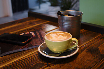 Coffee time - ceramics cup of excellent cappuccino with coffee art swan