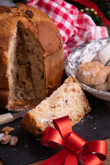 portion of panettone cut on the table with christmas decorations