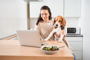 Woman having a healthy breakfast at the kitchen