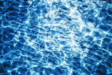 Sea wave background. Calm waves on shallow water. Ripples on lake water. Blue lake surface texture. Outdoor summe ocean perspective backdrop.