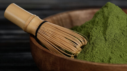 organic matcha green tea powder in wooden bowl. organic product for healthy life