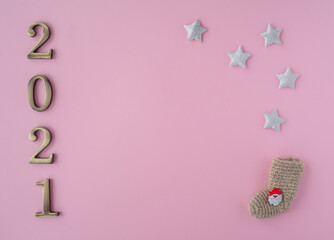 Fototapeta na wymiar Christmas 2021. Coronavirus new year minimal concept. Flat lay with metal numbers and decorative stars on pink background. top view, copy space