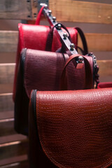 Leather bags holding on a show exhibitor in a shop with copyspace for text.