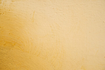 Yellow wall with old cracked paint.