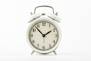 beige vintage alarm clock on white background