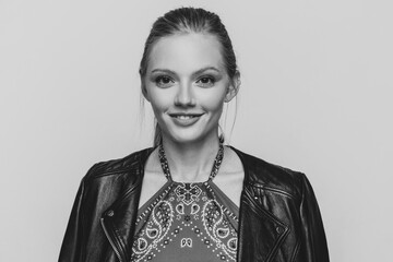 cool blonde model in leather jacket smiling