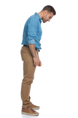 sexy casual man looking down at something