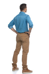 Naklejka premium casual man standing with his hands on his hips