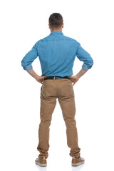 casual man standing with his hands on his hips