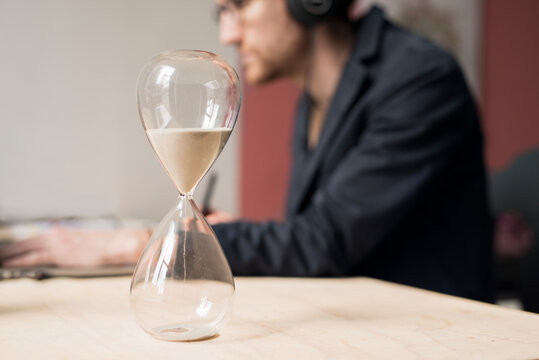 Hourglass, man working on background, Sweden