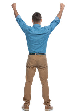 excited casual man celebrating succes with his arms up