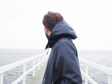 Man on jetty looking at sea, Sweden