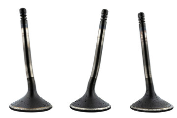 Warped three engine valves, covered with soot, isolated on a white background.