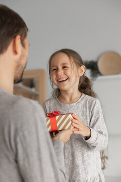 Child Daughter Congratulating Dad And Giving Him Gift Box