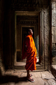 Novice monk in ruined building, Cambodia