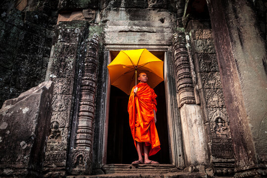 Novice monk in ruined building, Cambodia