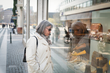 Woman looking in shop window, Sweden