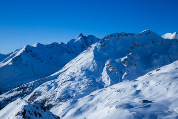 Drone image of mountains in winter. Image with snow, texture and shadows. 